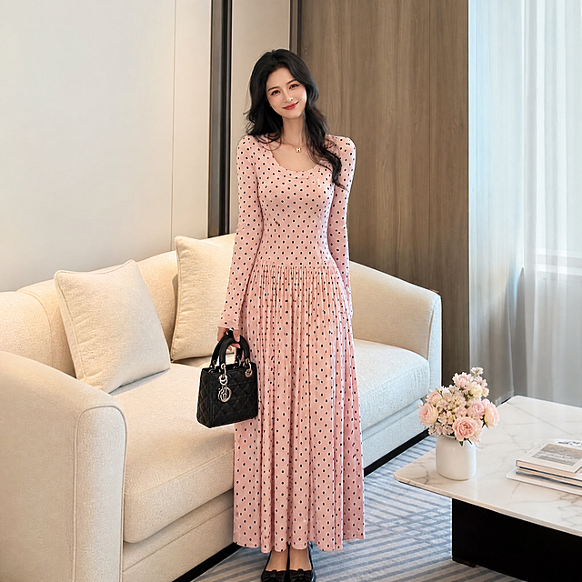亚马逊跨境电商主图，1:1正方形构图，粉色波点印花长袖大摆连衣裙穿搭场景展示，模特手持包包自然站立，整体呈现温柔优雅风格，粉色波点图案活泼甜美，简约轻奢室内场景，突出服装的日常穿搭效果和氛围感，专业电商摄影