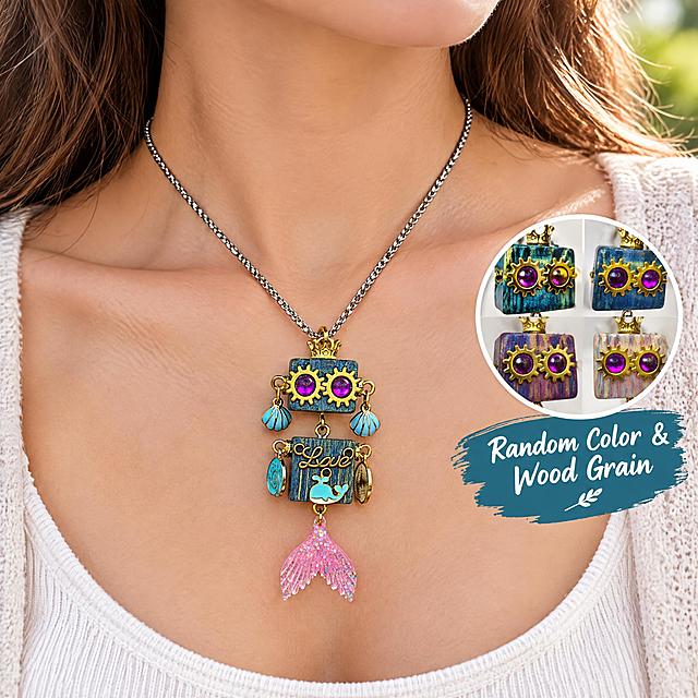 Amazon cross-border e-commerce main image, 1:1 ratio, scene display image, no white background. The product is a cute steampunk wooden robot pendant necklace with blue wood grain square body, golden gear eyes with purple gems, golden crown on top, light blue shell earrings, 'Love' lettering, light blue whale decoration, and pink glitter mermaid tail pendant. Pendant size: 7cm long, 2cm wide, 1.5cm high. The pendant is worn as a necklace on a female model's neck (showing neck and collarbone only), casual style, soft natural lighting, lifestyle photography. English text on the image: "Random Color & Wood Grain". Professional commercial photography, sharp focus, high detail, suitable for Amazon product listing.