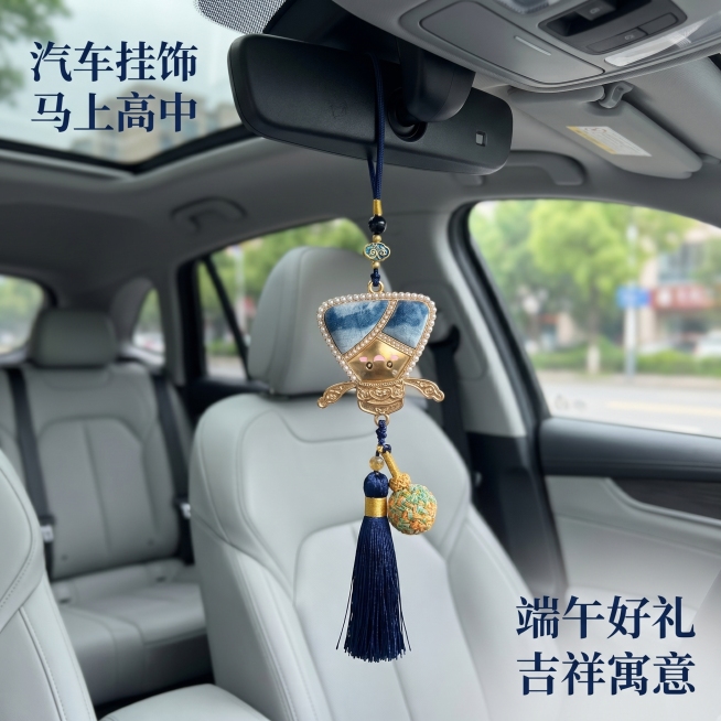 [主图 5] 汽车内后视镜悬挂展示；
[氛围风格] 真实车用场景，端午吉祥；
[画质] 商业摄影质感、光线柔和通透、产品清晰真实、画面干净高级。
[元素] 长款扎染粽子挂饰悬挂在汽车内后视镜上，展示车预览效果