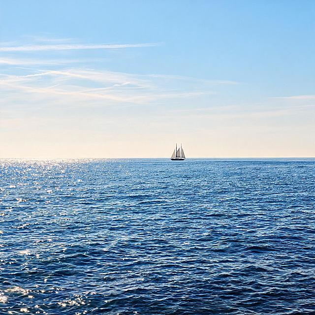 写实海景摄影，横版构图，开阔海平面视角。前景是深浅渐变的宝蓝色海面，细密波浪起伏，阳光在水面上点缀着星星点点的粼粼波光反光。平直的海平线横贯画面中下部，远处海平线上漂浮着一艘双桅帆船，白色三角船帆张开，深色船身小巧轻盈。天空从靠近海平线的浅乳白色向上渐变至清澈的浅天蓝色，几缕细长轻薄的白色云带横向舒展。整体氛围开阔宁静、澄澈治愈，大气通透，冷暖对比柔和，高清细节，自然光影，无任何文字。