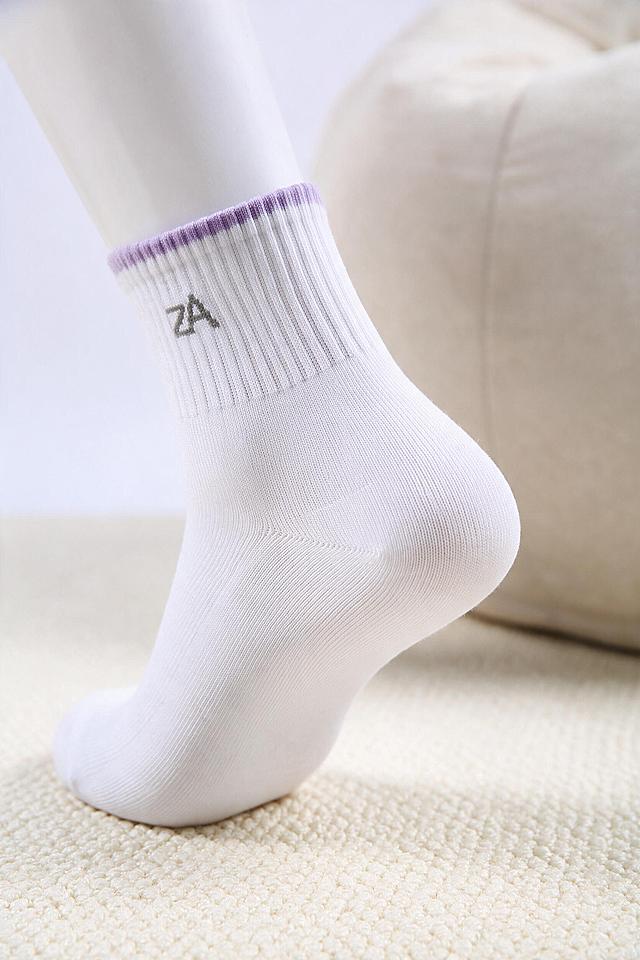 [商品] 使用【图3】【图2】为主参考；主体为白色针织女袜的袜跟部位，雾紫罗纹袜口位于画面后景，袜身小标保留不改写不替换；100%继承原图针织面料、纱线纹理、织物颗粒、原有印花、褶皱与明暗光影，禁止重新生成袜子材质；商品处理：袜子侧立摆放，袜跟弧面自然鼓起、保留立体包跟造型，增强织纹密度与弧形转折处的明暗过渡，不改变袜型、结构与颜色。
[画面] 页面目标：袜跟工艺细节页，纹理清晰还原；构图骨架：袜子侧立于米白哑光棉麻布面，袜跟朝向右前方并放大占画面约70%，袜筒向左上方延伸出画面，左上留出空白；景别微距特写，侧前方平视略俯；前中后景：前景米白哑光棉麻布面清晰颗粒织纹，中景侧立袜跟微距主体，后景虚化米色靠垫与柔和投影；摆放自然符合真实袜型，画面无杂物，极简留白。
[视觉] 套系策略：风格=韩系ins风微距静物摄影，低饱和莫兰迪色调，极简留白，浅景深，细腻面料纹理，8K高清商品摄影，柔和阴影，无反光；主色=米白#F3EFE8；背景延展=米白哑光棉麻质感与同色深浅渐变；强调色=雾霾紫#B9A7C9，仅以袜子本体袜口颜色自然呈现，不额外添加图形、引线与图标；光影=左前侧45°柔和自然光，柔和阴影。
[文字] 不需要文案：画面中不得出现任何文字、数字、字母、标签、方框、引线、弧线、水印、二维码、平台角标，保持纯净无文案画面。
[规格] 竖版2:3，分辨率2K，负向：人脸、畸形手脚、卡通、文字水印、任何文字元素、袜子变形、色彩失真、杂乱杂物、冷蓝冷灰色调、Logo错乱错字、模糊失焦。