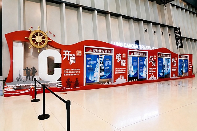 将这个红色文化展示墙整体修改为异形造型，保留所有内容布局、红色系风格和海军船舵、军舰、军人元素，仅改变整体外轮廓造型为异形设计