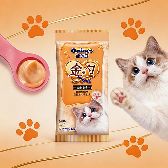 将图中间的产品包装替换为对应的橙色款佳乐滋金勺宠物零食包装，左侧粉色勺子和右侧布偶猫保持不变，背景为和包装匹配的浅橙色，猫爪印和金色线条元素保留，包装外的白底保持不变