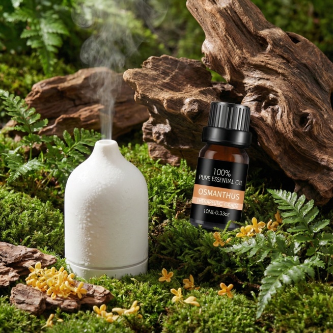 将图1中的精油瓶替换为图2的桂花精油瓶，并将乳香原料替换为桂花，生成后的图片要保持图1的自然氛围和光影效果，图片比例要1:1，图二精油瓶标签的颜色不要变动预览效果