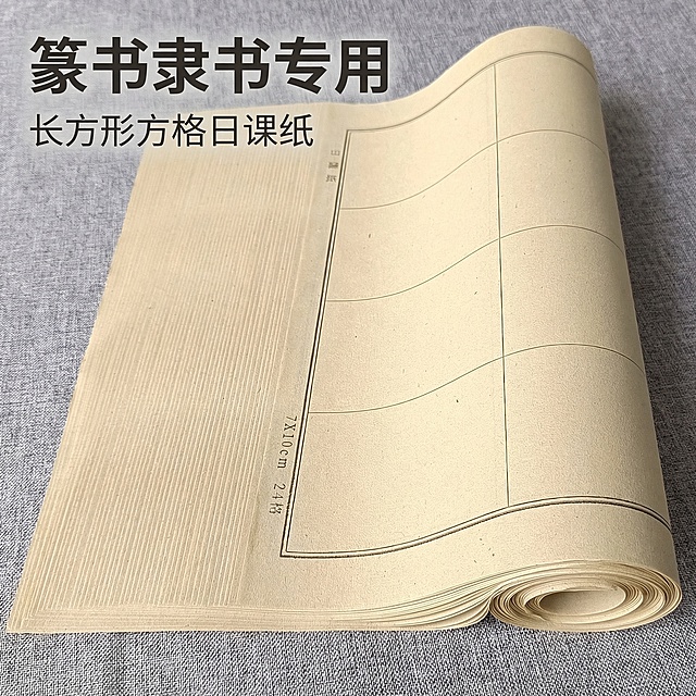 基于原图，在画面左上角添加文字，主标题“篆书隶书专用”字号稍大，副标题“长方形方格日课纸”字号稍小，保持原产品外观、颜色、材质、构图完全不变，背景保持原图灰色布料，整体风格简洁，符合拼多多电商主图规范，文字不遮挡产品主体，字色为深灰色，和纸张颜色对比清晰，层级分明