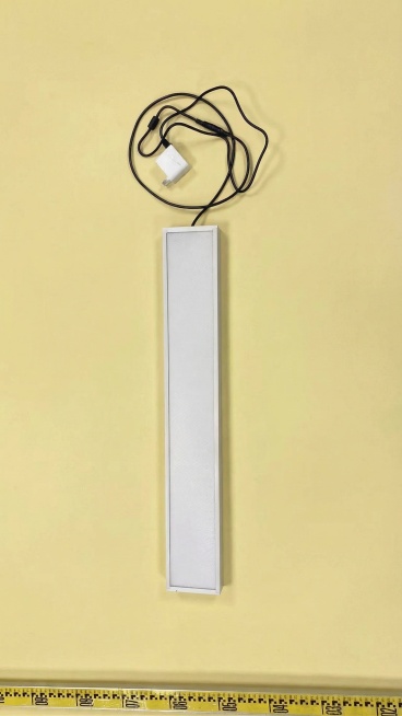 将图片的背景换成纯净的淡黄色，保留图中的长条灯具、电源线、电源适配器和底部的黄色卷尺，物品形态、位置、颜色保持不变预览效果