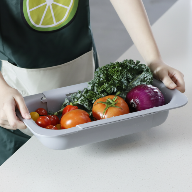 你是资深电商视觉设计师，请生成一张【电商主图】风格的产品图，用于电商详情页/投放素材。一张【塑料灰色可伸缩的沥水篮】的使用场景照片，要求不改变这款【灰色可伸缩的沥水篮】的样式和场景细节，消除图片中的水预览效果