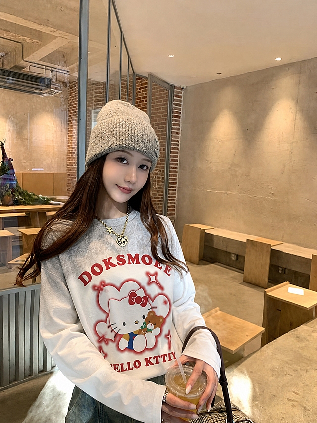 将图5的Hello Kitty白灰渐变宽松长袖T恤穿到图4模特身上，衣服版型为宽松版型，衣服的花色、图案、纹理、面料严格复刻参考服装，真实人像摄影，自然光，皮肤质感真实，高清，写实，柔和环境光影，衣服贴合身体，服装褶皱自然，无水印，无文字，无logo，无畸形肢体，画面干净，不要改变人物长相，保持原图的背景、姿势、配饰和整体构图不变