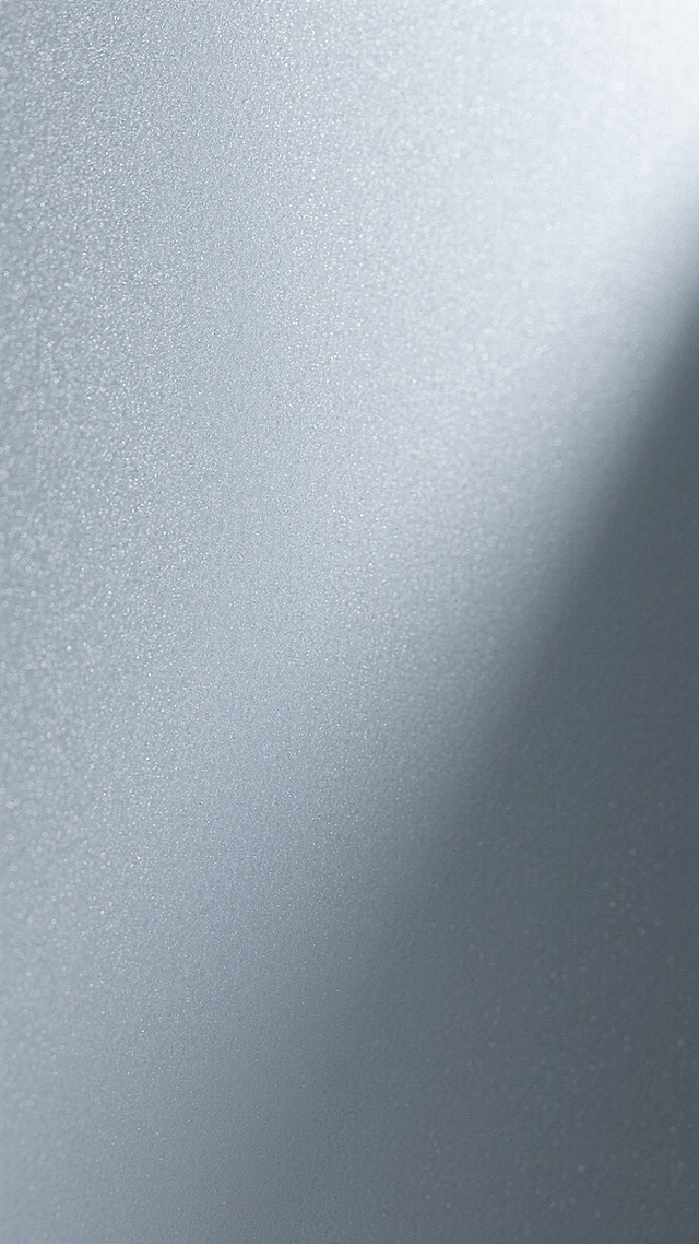 磨砂质感的灰色渐变背景，表面呈现细腻均匀的颗粒纹理，光线从右上方向左下方柔和过渡，高光区域明亮但不刺眼，阴影部分自然晕染，整体色调从浅灰到深灰平滑渐变，营造出低调沉稳且富有层次的视觉效果，具有现代简约的设计感，材质表现如同细腻的磨砂玻璃或高级灰卡纸，无任何文字或图案元素干扰。