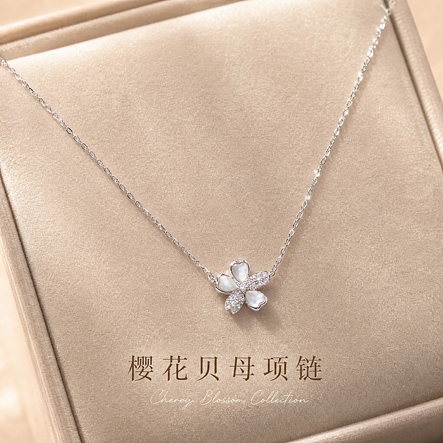 [主图-1] 樱花贝母镶钻银项链 首图氛围展示 突出高级礼赠感与产品身份。
[统一基调] 整体风格精致轻奢 柔光质感 背景为浅香槟色丝绒材质 标题字色为深香槟金 辅助字色为米白色 强调色为珍珠白 字体为纤细优雅的衬线体 字号层级分明 无厚重边框 整体克制高级。
[画面] 樱花贝母镶钻银项链居中陈列在浅香槟色丝绒托盘上 吊坠位于画面视觉中心 链条自然舒展呈V字形 吊坠樱花造型清晰 三瓣贝母温润有虹彩光泽 两瓣满镶碎钻闪耀火彩 金属部分为亮银色925银质感 产品占画面约60% 视角为正俯视微偏45度 丝绒托盘边缘隐约可见 背景干净无杂物。
[光影质感] 商业珠宝摄影质感 顶部柔光箱主光 两侧窄条轮廓光勾勒金属边缘 贝母呈现温润虹彩 钻石有细微星芒点光 金属表面反光干净 底部有柔和接触阴影 无过曝发白 整体光影柔和高级。
[配色] 主背景浅香槟色丝绒 产品亮银色+贝母珍珠白+钻石闪耀 文字深香槟金 整体色调统一温暖轻奢。
[文字版式] 画面底部居中位置 主标题「樱花贝母项链」深香槟金纤细衬线体 字号适中 下方一行小号手写体英文装饰「Cherry Blossom Collection」米白色 文字不遮挡产品 放在负空间 清晰可读。
[输出要求] 1:1比例 2048*2048px 产品清晰锐利 文字清晰 无变形 无错字 无模糊 无杂乱背景 无水印 无平台Logo 禁止塑料感高光 禁止廉价描边字。