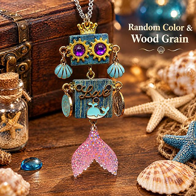 Amazon cross-border e-commerce main image, 1:1 ratio, scene display image, no white background. The product is a cute steampunk wooden robot pendant necklace with blue wood grain square body, golden gear eyes with purple gems, golden crown on top, light blue shell earrings, 'Love' lettering, light blue whale decoration, and pink glitter mermaid tail pendant. Pendant size: 7cm long, 2cm wide, 1.5cm high. Close-up shot showing the pendant details, placed on a vintage wooden table with small ocean-themed decorations around, warm soft lighting, lifestyle product photography style. English text on the image: "Random Color & Wood Grain". Professional commercial photography, sharp focus, high detail, suitable for Amazon product listing.
