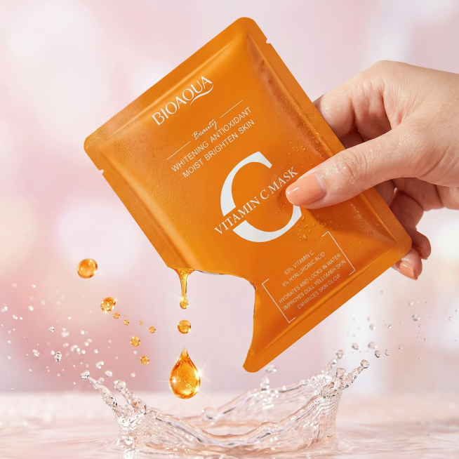 Dynamic close-up of a hand holding one vitamin C mask sachet, fresh orange serum dripping from the c预览效果