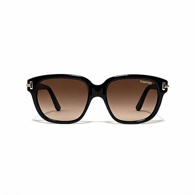 Front view of square sunglasses with thick black acetate frame, gradient brown lenses, and gold T-logo details on front of temples, based on reference image 429. Bold chunky frame design. Temples fully open and extended backward behind the lenses, temple arms visible through lenses curving backward, no temples visible above the top of the frame. Lying flat on pure white background with a soft contact shadow directly beneath the glasses, same shadow style and pose exactly as reference images 392, 393, and 394. Professional product photography, high quality, clean lighting, pure white background.