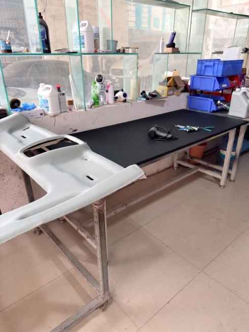 修图，把这张汽车内饰翻新门店的工作台环境图修干净整洁，去除地面污渍，清理杂乱感，保持原有物品布局不变，提升整体整洁度预览效果
