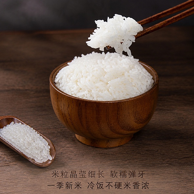 [主图-4] 连山有机丝苗米饭口感实拍图，展示米粒晶莹细长软糯弹牙一季新米冷饭不硬米香浓卖点，氛围诱人食欲，突出成品米饭真实口感，美食商业摄影，清晰细腻有食欲，光线通透，主体是一碗盛好的白米饭，一双筷子夹起一团米饭悬在碗上方，左下角放着一勺生米展示米粒形态，保持生米和煮好米饭的质感颜色形态和输入图片绝对一致，杜绝任何变形和色差，精细化处理，背景是深色木质桌面，简洁干净突出主体，商品主体占比约70%，侧上方柔和暖光，照亮米饭米粒，透出晶莹光泽，米饭颗粒清晰，暗部背景衬托主体，光影层次分明，主色调米饭洁白，木色暖棕，背景深灰，对比清晰突出米饭洁白晶莹，平视45度俯视角度，主体米饭碗占据画面中心，筷子夹起米饭是视觉焦点，前景生米点缀左下角，景深适中背景虚化，碗下方木质桌面留出空间，分两行居中排列卖点文字，上句"米粒晶莹细长 软糯弹牙"，下句"一季新米 冷饭不硬米香浓"，深棕色细黑体，分两行居中排列，字号适中清晰可读，不遮挡米饭主体，1:1 比例，4k 分辨率，文字清晰锐利，画面超高清，负向提示词：变形，文字错乱，产品图模糊，背景杂乱，水印，电商平台Logo，绝对化违禁词