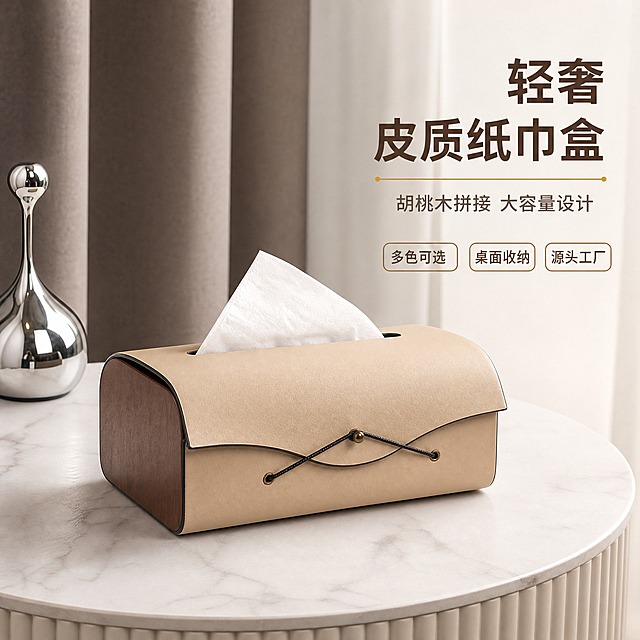 [主图-1] 轻奢皮革木质纸巾盒空间氛围英雄图，突出产品高级质感与居家装饰属性。
[统一基调] 现代轻奢风格，整体色调以奶咖色、深胡桃木色、高级灰为主，背景为柔和的侘寂风居家场景，自然午后柔光从侧上方照射，字体采用简洁无衬线粗体，标题字色为深棕色，辅助文字为暖灰色，强调色为古铜金色，整体干净高级有B端源头品质感。
[画面] 画面中心偏左位置放置一个奶咖色皮革+胡桃木端板的纸巾盒作为绝对主视觉，主体占比约65%，45°平视视角，盒盖自然闭合，顶部抽纸口露出一张白色抽纸呈三角形态。产品放置在白色大理石圆形边桌上，桌面有自然大理石纹理。背景虚化呈现浅灰色布艺窗帘与深咖色竖纹窗帘的层次感，左侧点缀一个银色水滴造型金属装饰摆件，右侧留白用于放置文字。产品下方有自然柔和的接触阴影，皮革表面呈现细腻的哑光皮质纹理，胡桃木端板有清晰自然的木纹，金属扣与穿绳细节精致清晰。
[光影质感] 商业摄影级质感，主光源来自左上方45°，形成柔和的明暗过渡，皮革表面有微弱的环境反光，木质部分呈现温润的哑光质感，整体光影自然真实，阴影柔和不生硬。
[配色] 主色：奶咖色、胡桃木棕、高级灰；背景色：米白、浅灰、深咖渐变；文字色：主标题深棕色，副标题暖灰色，强调色古铜金。
[文字版式] 画面右上角留白区域竖排主标题，主标题大字粗体：轻奢皮质纸巾盒；下方小字辅助文案：胡桃木拼接 大容量设计；再下方三个小标签横向排列：多色可选 桌面收纳 源头工厂。文字不遮挡产品主体，字号层级分明，整体简洁大气符合1688 B端品质感。
[输出要求] 1:1正方形，2K高清，产品清晰不变形，文字清晰可读，无水印无平台logo，无多余杂物，画面干净高级。负向：产品变形、色差、模糊、悬浮、穿模、错字、杂乱背景、水印、平台标识。