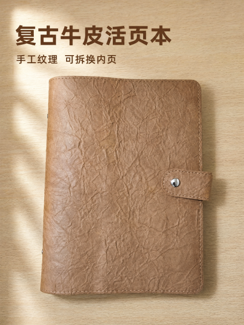 [主图-1] 封面展示-复古牛皮纸活页手账本首图。[氛围风格] 简约复古质感，文艺办公文具风。[画质] 商业摄影质感、光线柔和通透、产品清晰真实、画面干净高级。[元素] 棕色做旧纹理活页笔记本闭合状态预览效果