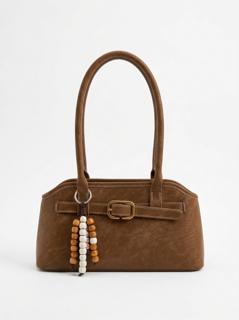 对图中的棕色包包进行精修，清除所有指纹、灰尘、划痕，包包保持完美无瑕，保留包包正面完整形态，包包占画面60%，背景替换为纯白色无阴影，使用专业影棚光效，突出产品高级感，画面达到商业级4K超清画质，极致预览效果