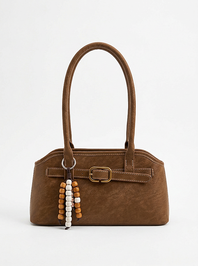 对图中的棕色包包进行精修，清除所有指纹、灰尘、划痕，包包保持完美无瑕，保留包包正面完整形态，包包占画面60%，背景替换为纯白色无阴影，使用专业影棚光效，突出产品高级感，画面达到商业级4K超清画质，极致锐利，细节分明，主体突出