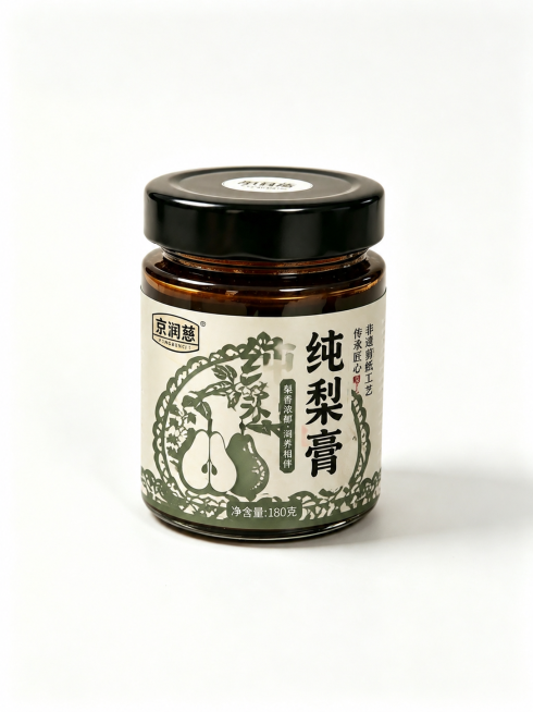 保留玻璃罐子和黑色瓶盖的形状，重新设计梨膏标签包装：包装融入非遗剪纸元素，剪纸内容和梨相关，品牌保留为京润慈，配色适配剪纸风格，整体高级简洁，采用和前两个版本都不同的剪纸风格和主色调，保持原图构图，原预览效果