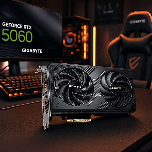 [场景图3-电竞桌面全景] 技嘉RTX 5060显卡放在前景位置，背景是整套电竞桌面，包含电竞显示器、机械键盘、电竞椅，氛围灯条，整体营造完整电竞使用场景。保持显卡外观与参考图一致，景深效果背景虚化突出显卡，光影氛围感强，暗调暖光源点缀，1:1构图，超高清4K。负向提示词：变形，水印，文字错乱，产品模糊，背景杂乱。