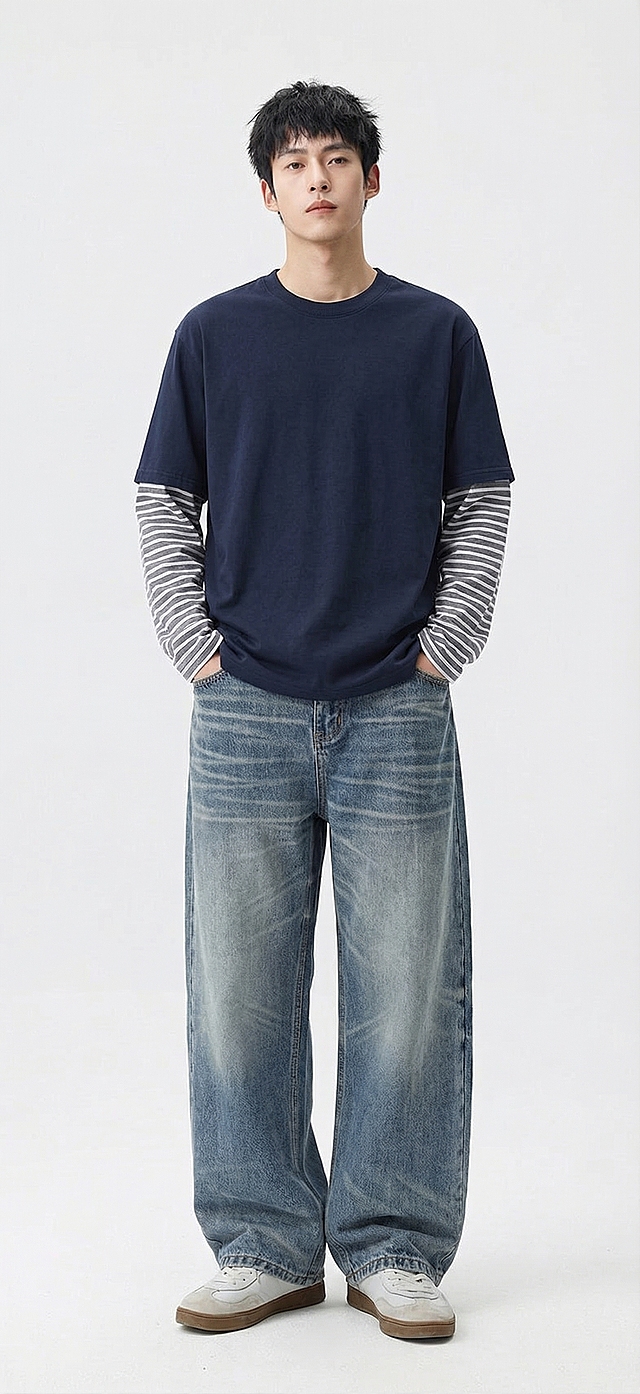 将图1的藏青假两件条纹长袖T恤、图2的水洗蓝阔腿牛仔裤，替换到图3的男性模特身上，保持模特原本的站姿和背景，服装贴合模特身形，效果自然真实