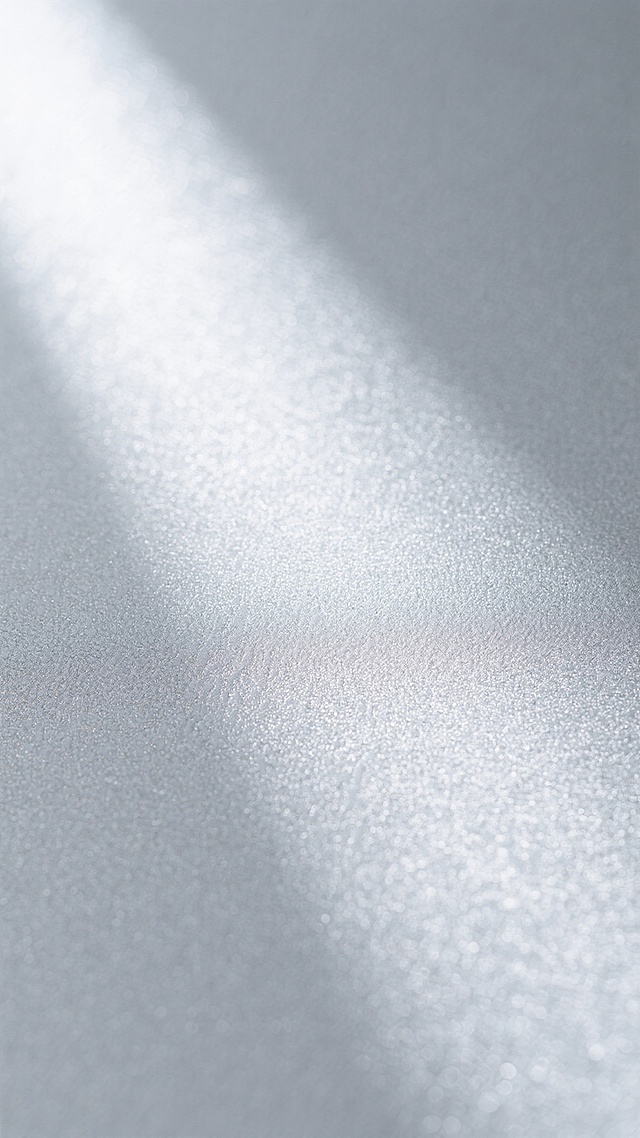 一张银色背景的图片，具有细腻的磨砂质感纹理，整体呈现出柔和的光泽感，光线均匀地洒在表面，形成微妙的光影变化，不同区域有着细微差别的纹路走向，共同构成一个统一且富有层次感的银色磨砂背景。