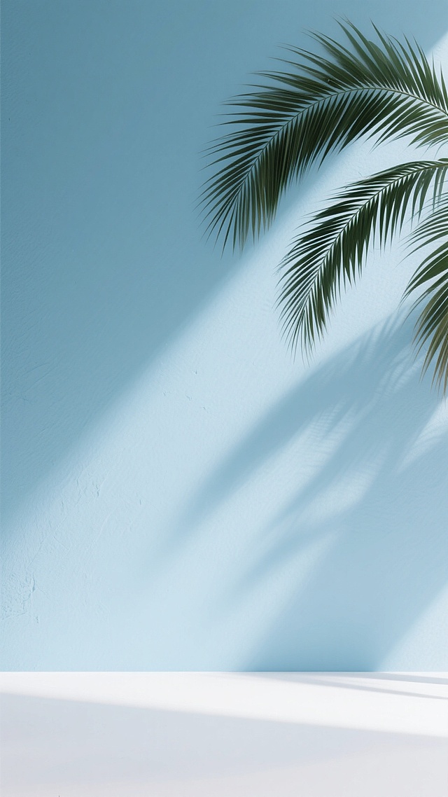 低饱和度淡蓝色背景为主，左上方斜射柔和光线，墙面清晰优雅棕榈叶阴影，底部平滑白色过渡，轻盈空气感与自然光影韵律，干净风格符合现实逻辑的背景素材提示词