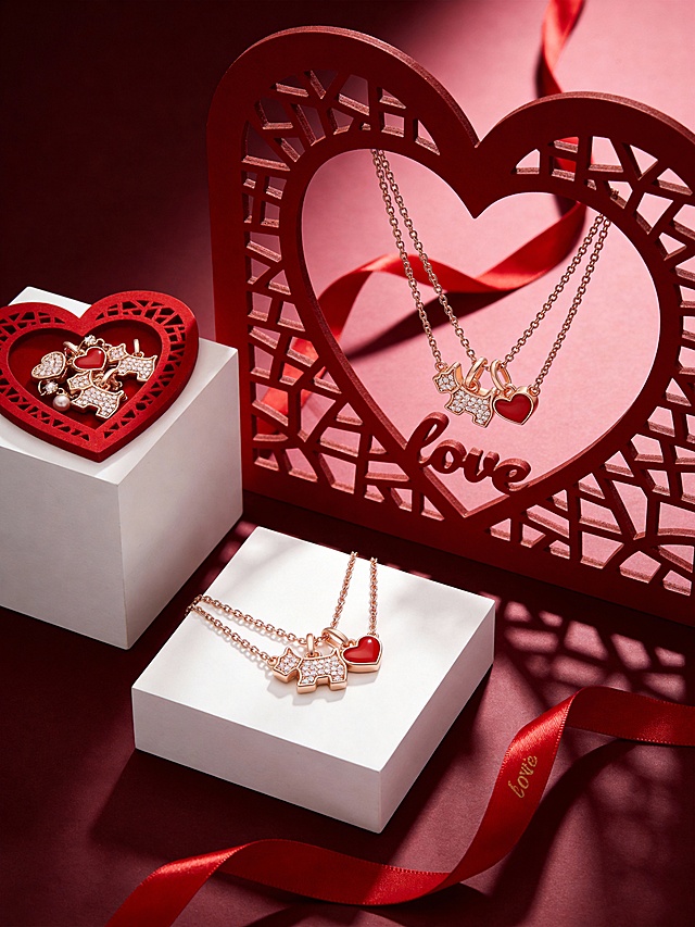 奢华高级风商业珠宝静物摄影风格，画面以深邃酒红色为背景主色调，搭配金属银与正红色爱心造型作为视觉点缀，整体色调浓郁且富有高级感。采用平视略俯视的视角，主体分为两组：一组置于画面左侧的红色镂空爱心造型内，呈自然堆叠角度；另一组悬挂在右侧的大型镂空红色爱心框架中，大小适中且形成视觉平衡，搭配红色飘逸丝带（丝带上印“love”）。背景为纯净的酒红色渐变，营造出简约而高级的空间感。采用柔和的侧逆光结合局部轮廓光，营造出细腻的明暗层次与柔和阴影，主体与浪漫奢华的场景融为一体，充满情人节的甜蜜氛围与视觉张力。