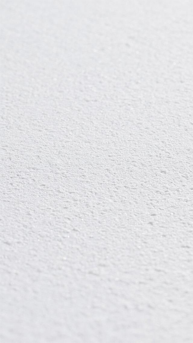 一张纯白色背景，具有细腻均匀的浅灰色纹理，纹理呈现出不规则的细微颗粒感和轻微的斑驳效果，整体质感柔和、干净，适合作为设计背景使用。