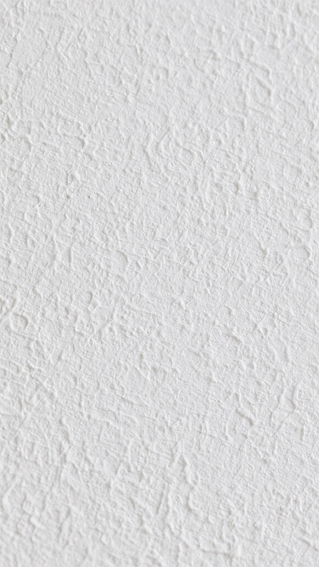 一张纯白色背景的图片，表面呈现出细腻且均匀分布的不规则纹理，纹理清晰可见，具有类似磨砂质感或轻微粗糙的墙面质感，整体视觉效果干净、素雅，光线均匀柔和，无明显阴影和高光对比，纹理细节丰富且层次分明。