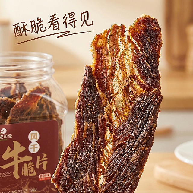 [主图主题] 风干牛脆片细节微距展示
[氛围/风格] 微距特写，极致食欲感
[画面元素] 微距镜头聚焦单块牛脆片特写，展示风干牛肉的清晰纹理和酥脆肌理，自然暖逆光穿过脆片，突出肉质干燥均匀的质感，旁边搭配半罐打开的产品作为衬托，整体画面质感干净诱人
[配色色系] 主色调：深棕牛肉纹理色；辅助色：深红标签点缀
[视角构图] 微距特写，牛脆片占据画面中心，景深较浅突出纹理细节
[文字版式] 左上角“酥脆看得见”棕色手写体文字，文字不遮挡牛脆片主体，整体风格简洁高级，产品细节真实还原，产品外观保持与原图一致
[比例分辨率] 2k分辨率