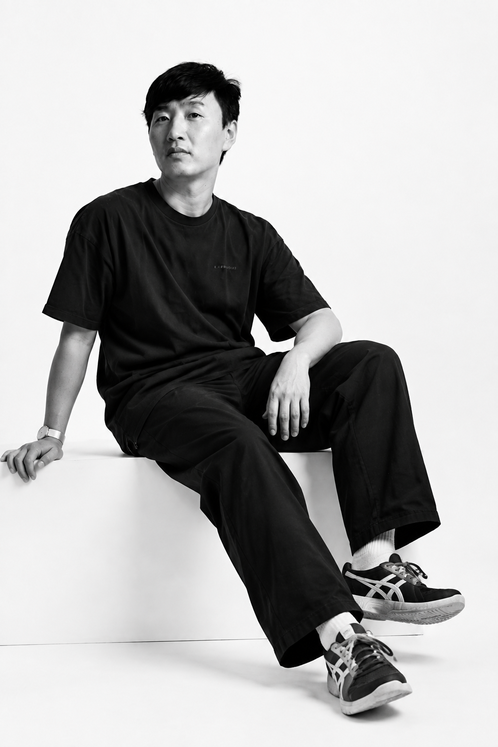 调整人物动作和角度，让坐姿和身体姿态更自然放松，保持黑白影棚写… - 图片创意预览