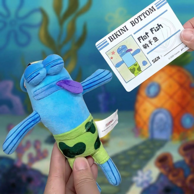 保留原比奇堡居民躺平鱼毛绒盲盒，保留卡片和文字内容不变，更换背景为比奇堡海底世界风格，背景做虚化处理，突出作为视觉中心的盲盒，盲盒本身保留原有的丑萌丧系表情、软萌毛绒材质，其余内容保持完全不变预览效果