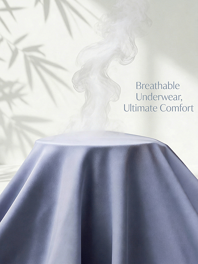 在图片的合适空白位置添加文字“Breathable Underwear, Ultimate Comfort”，保留原图中覆盖布料的蒸汽和竹叶阴影，保持原图片整体风格和色调不变