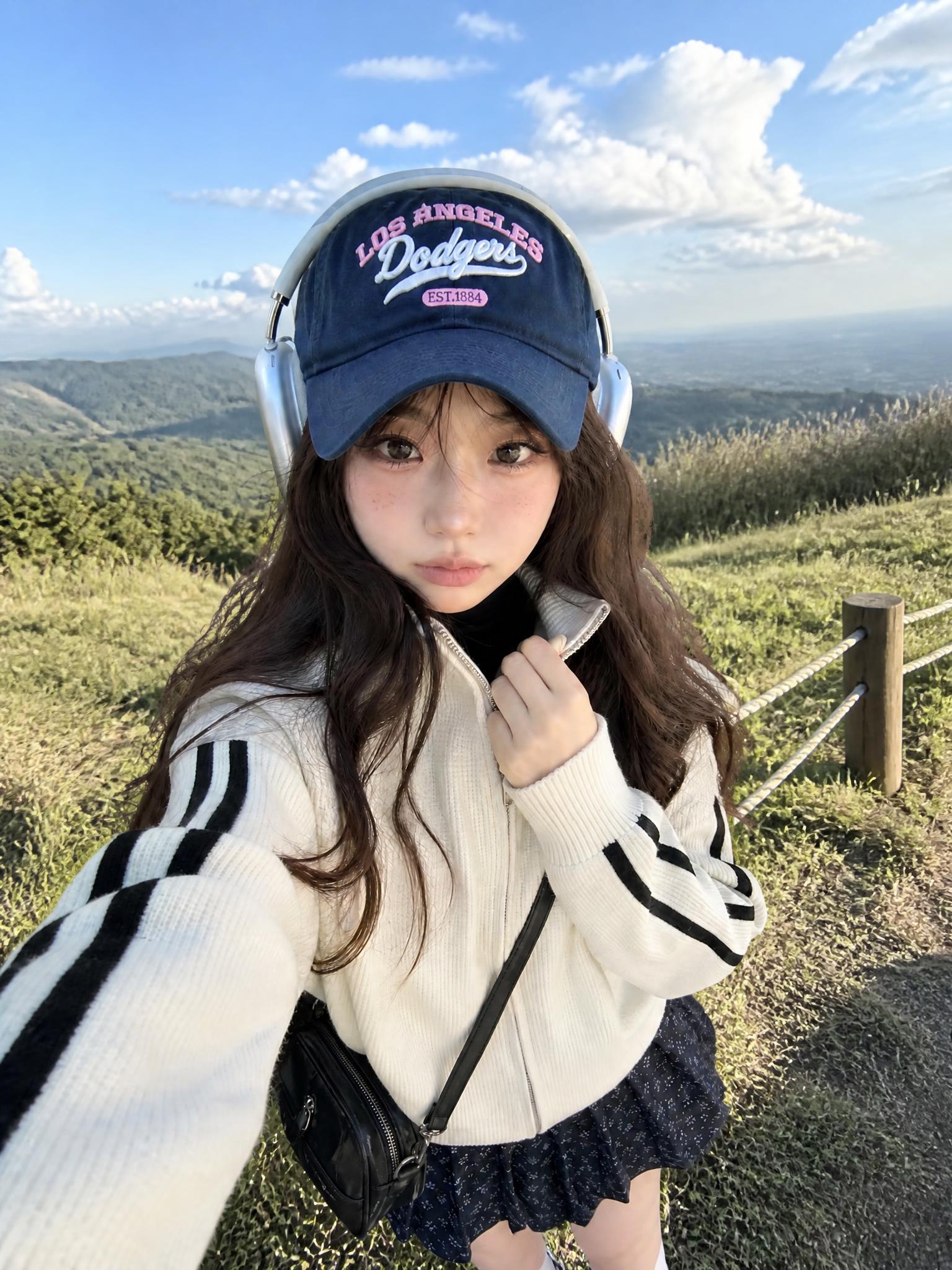 以图中女生的外貌和穿搭为基准，生成一张她出游的照片，背景为户外… - 图片创意预览