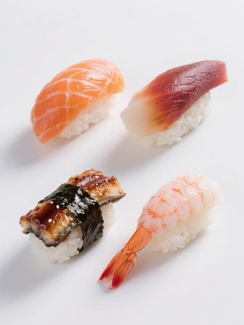 超写实日料美食摄影风格，纯白纯色背景，四个完全不同的日料寿司元素规整对称排布成系列素材集合，每个寿司都具有清晰的纹理细节和自然的光影效果，分别为：三文鱼腩寿司（橙红色鱼肉带白色脂肪纹理，光泽饱满）、金枪鱼寿司（深红色鱼肉紧实有弹性，表面微湿）、鳗鱼寿司（棕黑色蒲烧鳗鱼，覆盖光泽酱汁，鱼肉柔软）、虾寿司（粉白色虾肉Q弹，尾部带橙红色，肉质透明感），所有寿司米粒洁白松散有颗粒感，整体构图平衡，视觉……预览效果
