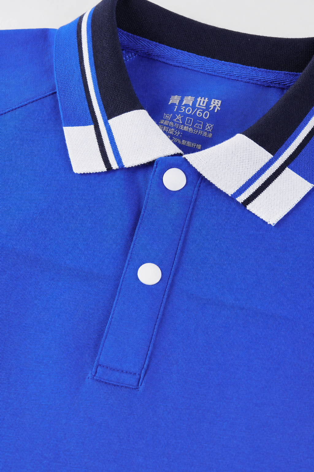 在这件蓝色Polo领校服的胸前面料区域，添加一道非常轻微自然的… - 图片创意预览