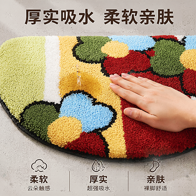 [主图-2] 亲肤吸水体验展示纱线针织植绒地毯。保持地毯外观花色与原图一致，展示水滴落在地毯毯面上被快速吸收的效果，一只手的手背轻触地毯绒面，突出柔软亲肤触感。背景保持与主图1相同的入户玄关浅灰色地面，统一光源方向和温馨暖调自然光风格。商品主体占画面约75%，画面干净。光影：主光从正面照射，突出绒面蓬松柔软的质感，水滴呈现透明清晰效果，光线柔和通透。配色：延续主图1配色，地毯彩色搭配浅灰背景。视角平视对焦在绒面和水滴位置，浅景深突出主体。文字版式：顶部悬浮大标题写"厚实吸水 柔软亲肤"，深棕色大字居中；画面底部均分三列，每列图标加文字：第一列图标加文字"柔软" "云朵触感"，第二列"厚实" "超强吸水"，第三列"亲肤" "裸脚舒适"，文字清晰配色对比明显，不遮挡主体。1:1比例，4k分辨率，超高清文字清晰。负向提示词：变形，水印，文字错乱，产品模糊，背景杂乱。