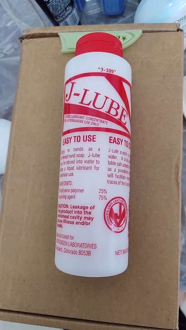 Place the powder bottle from the second image onto the cardboard background of the first image, matching the original image's perspective, lighting and composition, only replacing the product